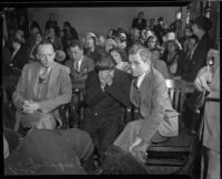 Louis Rude Payne, with father Lucius Payne at his side, at his inquest for the murder of his mother and brother. June 6, 1934