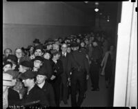 Police regulate a crowd of Robert Noble's supporters who have come to greet Noble as he enters the courthouse to face misdemeanor charges, Los Angeles, November 3, 1937