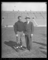 Football player Red Grange in uniform and sports promoter C. C. Pyles at Los Angeles Memorial Coliseum, 1923