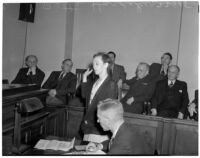 Betty Flay Hardaker takes an oath while on trial for murdering her daughter, Los Angeles, 1940