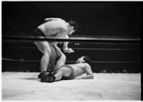 Heavyweight wrestler El Pulpo grappling with an opponent at the Olympic Auditorium, Los Angeles, 1937