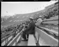 Crowd at the Coliseum during a football game between the UCLA Bruins and Loyola Marymount Lions, Los Angeles, circa 1935