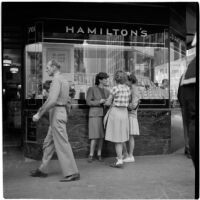 Woman talks to two truant girls standing outside a jewelry store, Los Angeles, March 1946