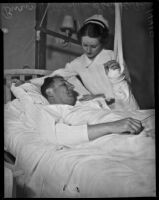 Buron Fitts in the hospital with a gunshot wound being tended to by a nurse, Los Angeles, 1937