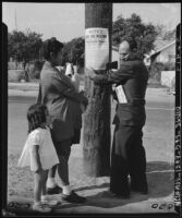 Posting a sign regarding bus service to Chavez Ravine in Los Angeles