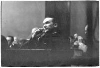 Widower Robert S. James sitting in a courtroom during an inquest involving his wife's death, Los Angeles, 1935