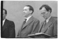 Murder suspect Robert S. James standing between two unidentified men in court, Los Angeles, 1936