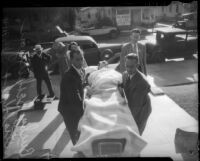 Choreographer and film director Busby Berkeley being carried into his manslaughter trial on a stretcher, Los Angeles, 1935