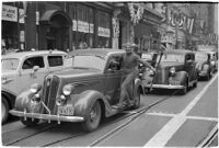 Man dressed in a devil costume riding a car in the Mystic Shriners' Durbar festival street parade, Los Angeles, 1937