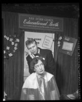 Reporter Buzz Salisbury having her hair styled by Earl B. Adams of Hair Design Council booth at International Congress of Beauty in Los Angeles, Calif., 1954