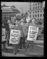 CIO Political Action Committee members with Stalin masks and signs reading "Free 10 Million Workers in Soviet Slave Labor Camps" protesting in Los Angeles, 1949