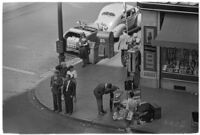 Aerial view of pedestrians and Owl Drug on the corner of Hollywood and Vine, Los Angeles, 1940