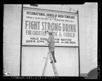 Paul Tarsen painting sign for International Order of Good Templars in Los Angeles, Calif., 1940