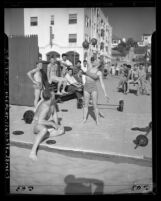 Bodybuilder Abbey Stockton lifting barbell as crowd looks on at Muscle Beach in Santa Monica, Calif