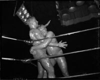 Prince Bhu Pinder pins Sandor Szabo against the ropes during a mud wrestling match at Olympic Auditorium, Los Angeles, October 20, 1937