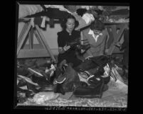 Actresses Dolores Del Rio and Claudette Colbert sorting shoes for International Committee for Refugees in France, circa 1940