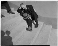 Spectator taking a break between races at Santa Anita Park, Arcadia, March 2, 1940