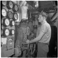 Man operates a machine during the Army-Navy maneuvers off the coast of Southern California in late 1946