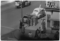 Aerial view of pedestrians and Owl Drug on the corner of Hollywood and Vine, Los Angeles, 1940