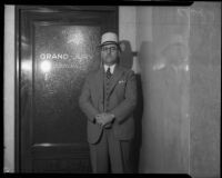 Charles N. Stevens stands before Grand Jury Room, Los Angeles, 1930's