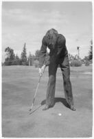 LA Daily News city editor Charles Judson demonstrates improper golf swings for a tutorial series with golfer Fay Coleman. Circa 1940