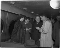 Betsey Cushing Roosevelt and attorney Basil O'Connor speaking with reporters, Los Angeles, February 29, 1940