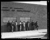 Men waiting outside California Department of Employment, Farm Labor division in Los Angeles, Calif., 1954