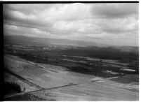 Aerial view of rushing flood waters moving down the Los Angeles River in North Hollywood, Los Angeles, 1938