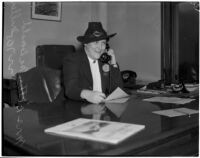 Mrs. Betty McDonald Miller talking on the telephone while sitting at a desk, Los Angeles