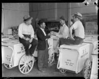 Striking ice cream vendors sit on push carts, Los Angeles, 1937