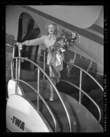 Actress Marlene Dietrich exiting airplane in Los Angeles, Calif. after entertaining troops during World War II