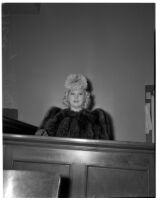 Mae West sitting in court during questioning about earnings from her role in the movie "She Done Him Wrong," Los Angeles, 1940