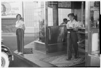 Drive-in waitress carrying a meal to a customer, Los Angeles, 1937