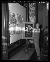 City councilman Harold V. Harby debating merits of Edmond Kohn's "Bird on the Moon" painting given to the city of Los Angeles, 1954