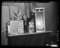 Charles Caudle using puppets and props for lecture on the do's and don'ts during an atomic bomb attack in Los Angeles, Calif., circa 1951