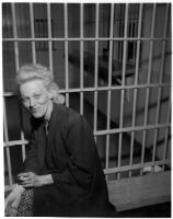 Louise Henderson Carringer sits in jail after police officers find her seven-year-old daughter, Linda Carringer, asleep alone in a car, Los Angeles, 1947