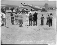 Crowd gathers to catch a glimpse of the airplane that set a world record, flying non-stop from Moscow to southern California. July 14, 1937