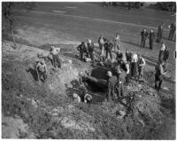 Men attempt repairs on damage caused by the Elysian Park landslide, Los Angeles, November 1937