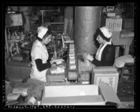 Two women packaging butter at State Relief Administration cooperative in Los Angeles, circa 1940