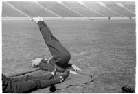 USC track athlete stretching on the field at the Coliseum, Los Angeles, 1937