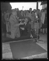 Ezio Pinza joking with Jimmy Durante as Pinza leaves his imprints at the Chinese Theater in Los Angeles, Calif., 1953