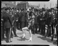 Drum majorette Betty Atkinson poses with officers during annual LAPD parade, July 9, 1937