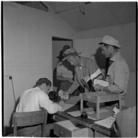 Veterans filling out paperwork to purchase Quonset huts and other surplus military supplies, Port Hueneme, July 15, 1946