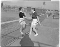 Mrs. Frances Hjelte and Mrs. Virginia Petticord shaking hands on the tennis court, Los Angeles