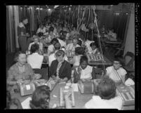 Corridor filled with men and women tabulating ballots for California primary election in Los Angeles, Calif., 1954