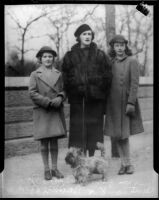 Mrs. William Gibbs McAdoo Jr. walking a dog with her daugthers Cynthia and Mimi, Los Angeles, 1930s