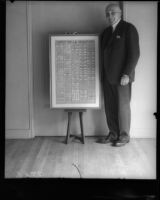 California Governor Frank Finley Merriam next to a copy of the United States Constitution, Los Angeles, 1930s