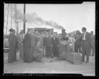 Men watching smog control device experiment on smoke stack in Los Angeles, 1948