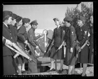 Eight women of Bundles for Bluejackets being instructed on using rifles by a Los Angeles County sheriff, circa 1942