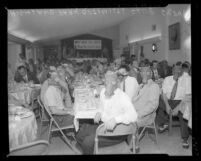 Highland Park Optimist Club wearing smog-gas masks at banquet, Los Angeles, Calif., circa 1954